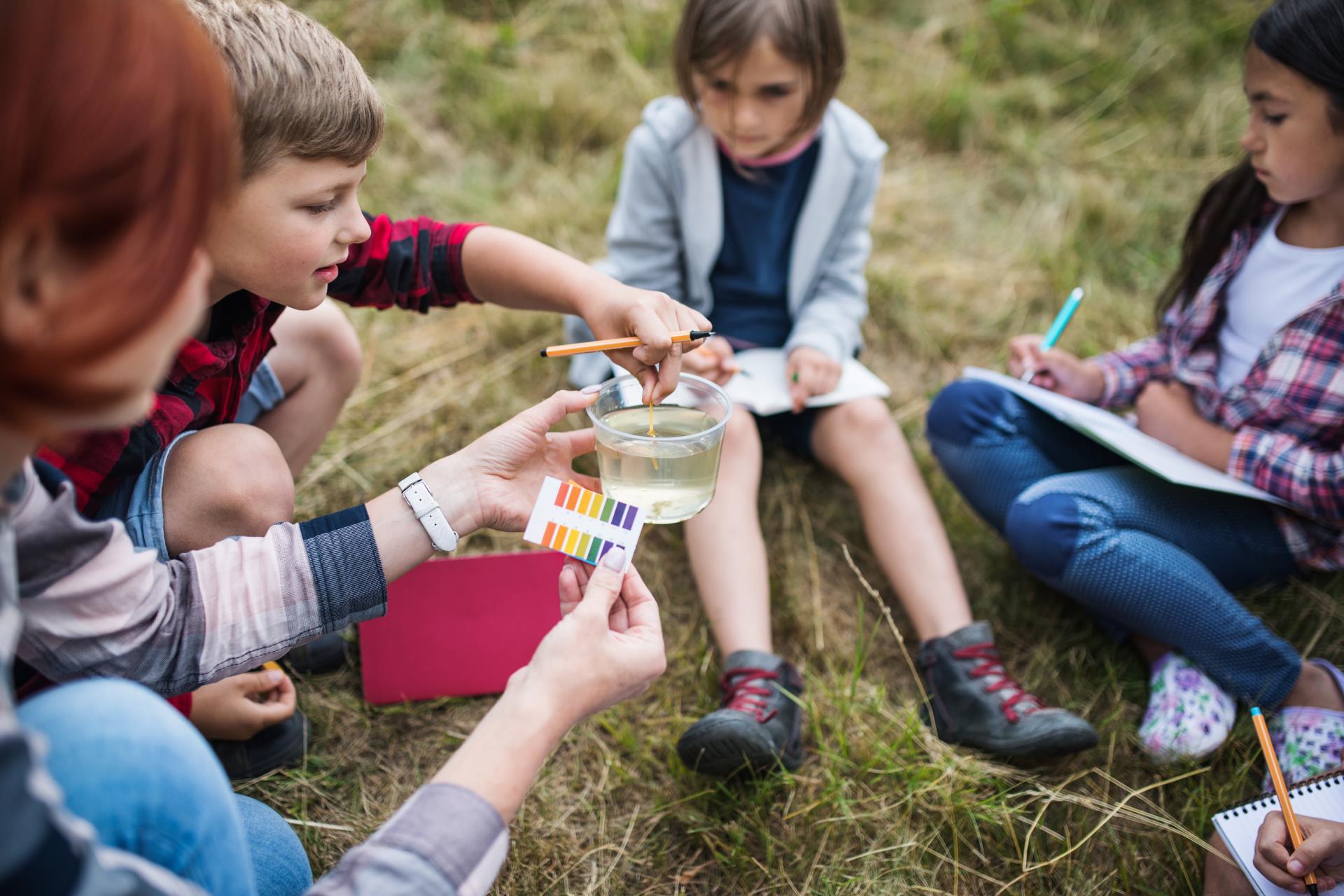 Kids outside doing science experiment together