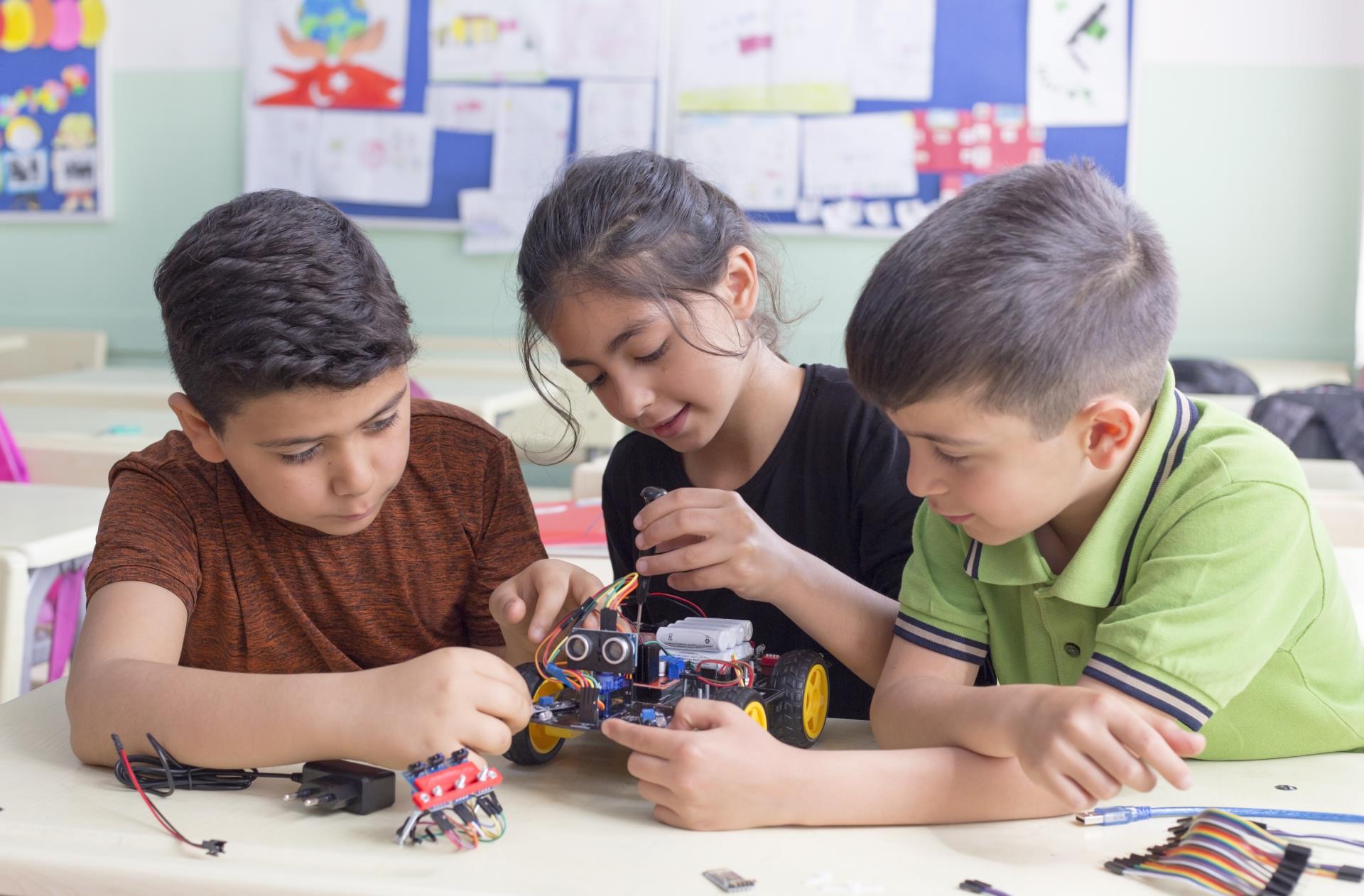 Kids building a robotic vehicle