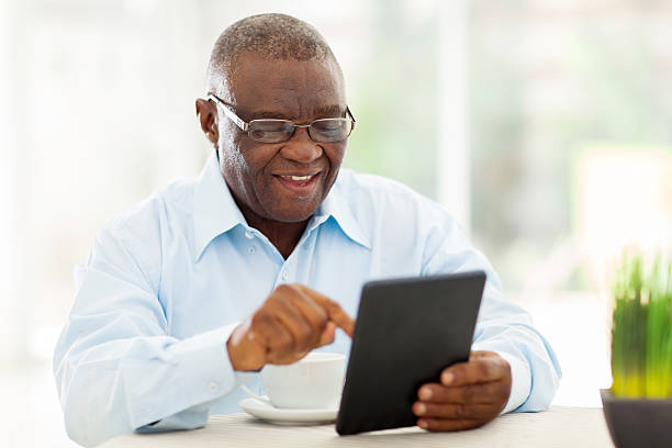 Senior man dark complexion with tablet