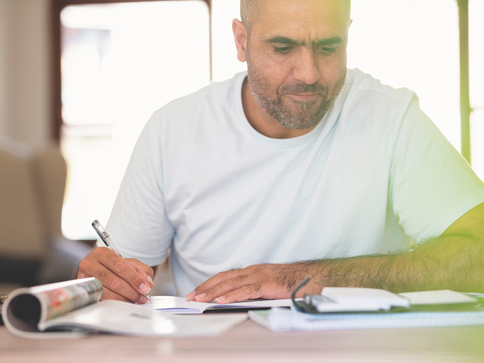 online studying mature man desk pen book