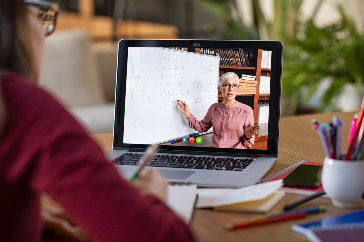 Young adult glasses student watching lesson online and studying from home