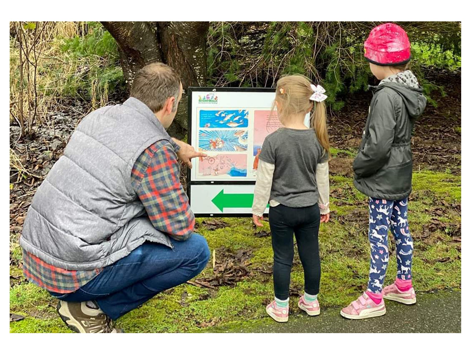 Family with kids looking at Story board