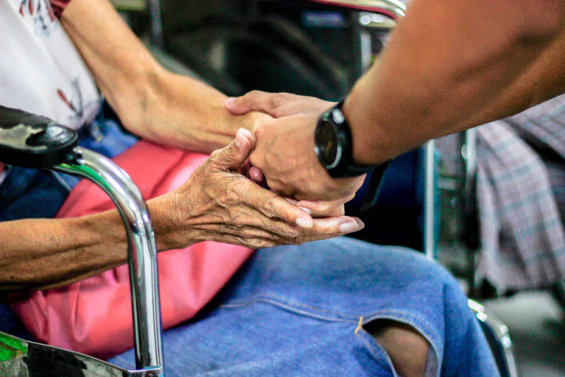 senior holding hand of caretaker