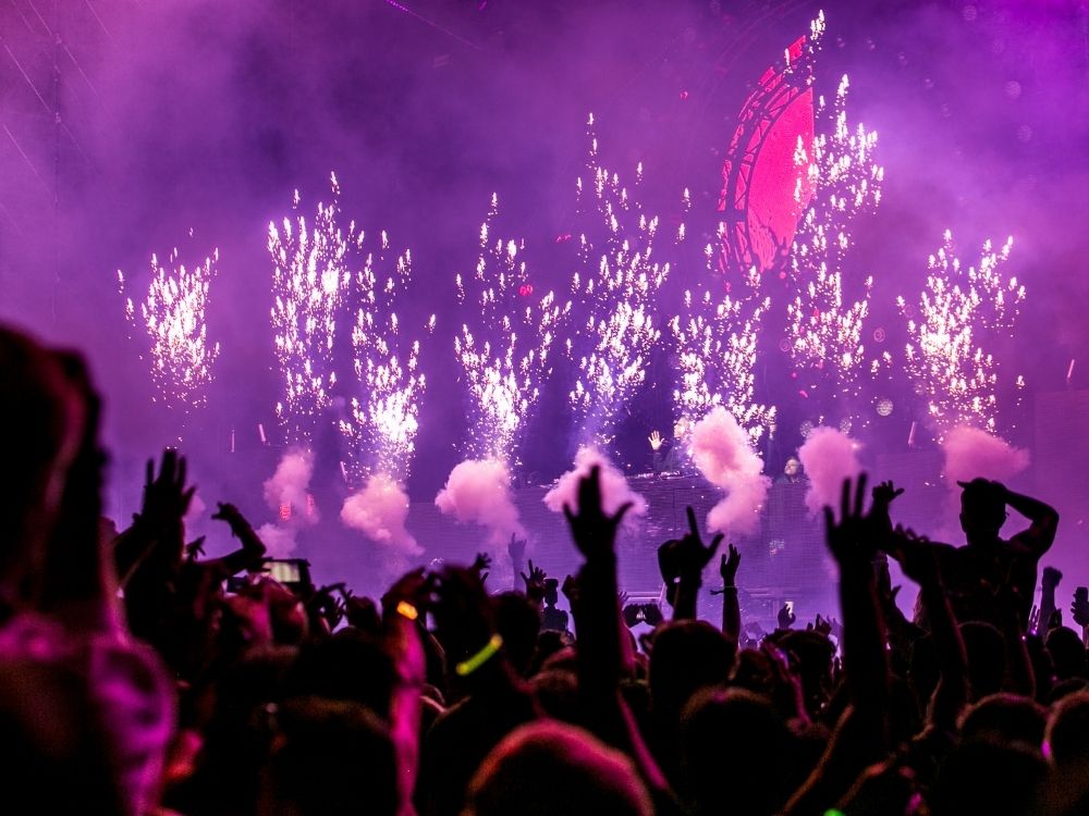 people at concert with purple lights