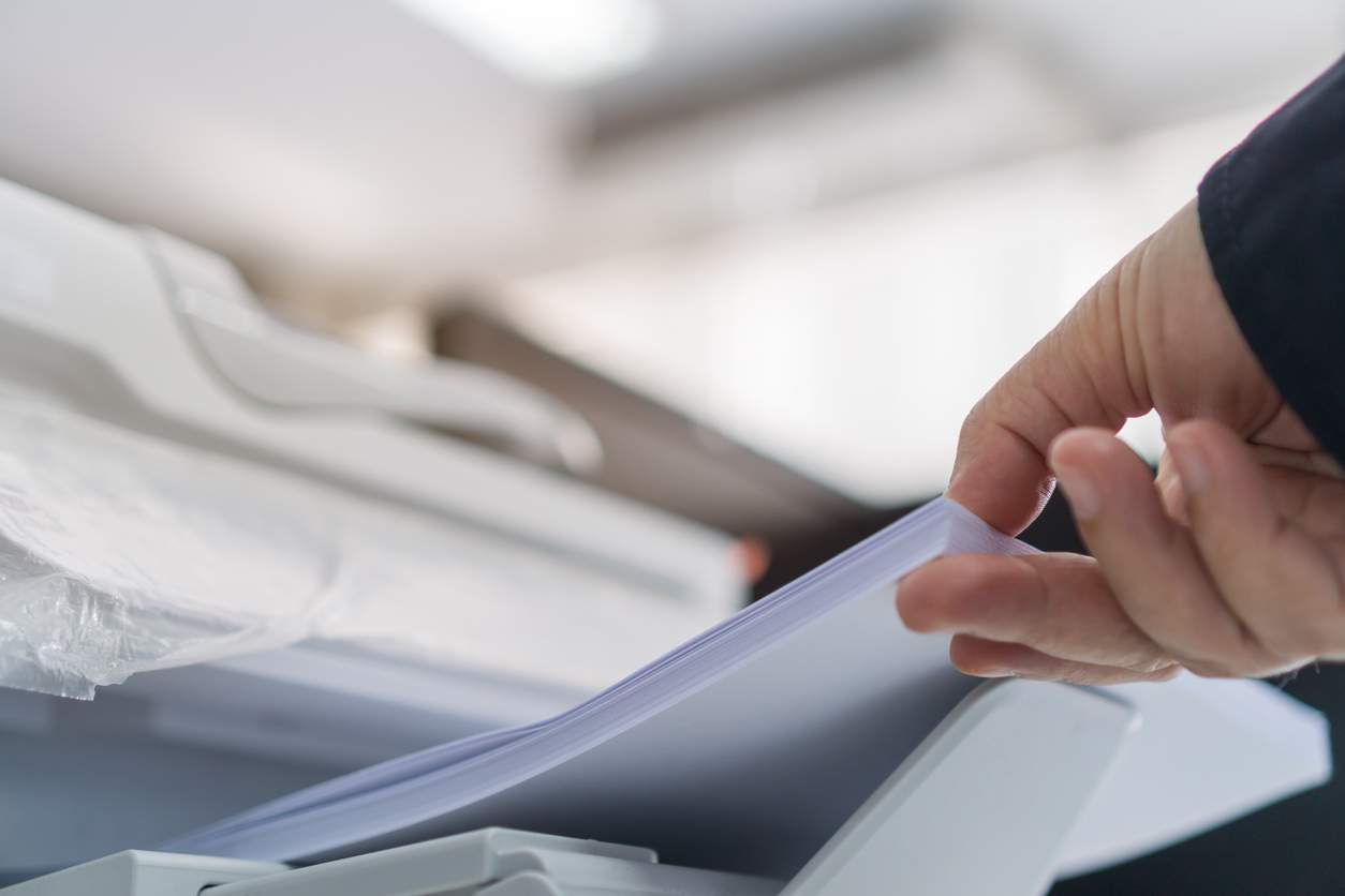 Hand holding printer paper