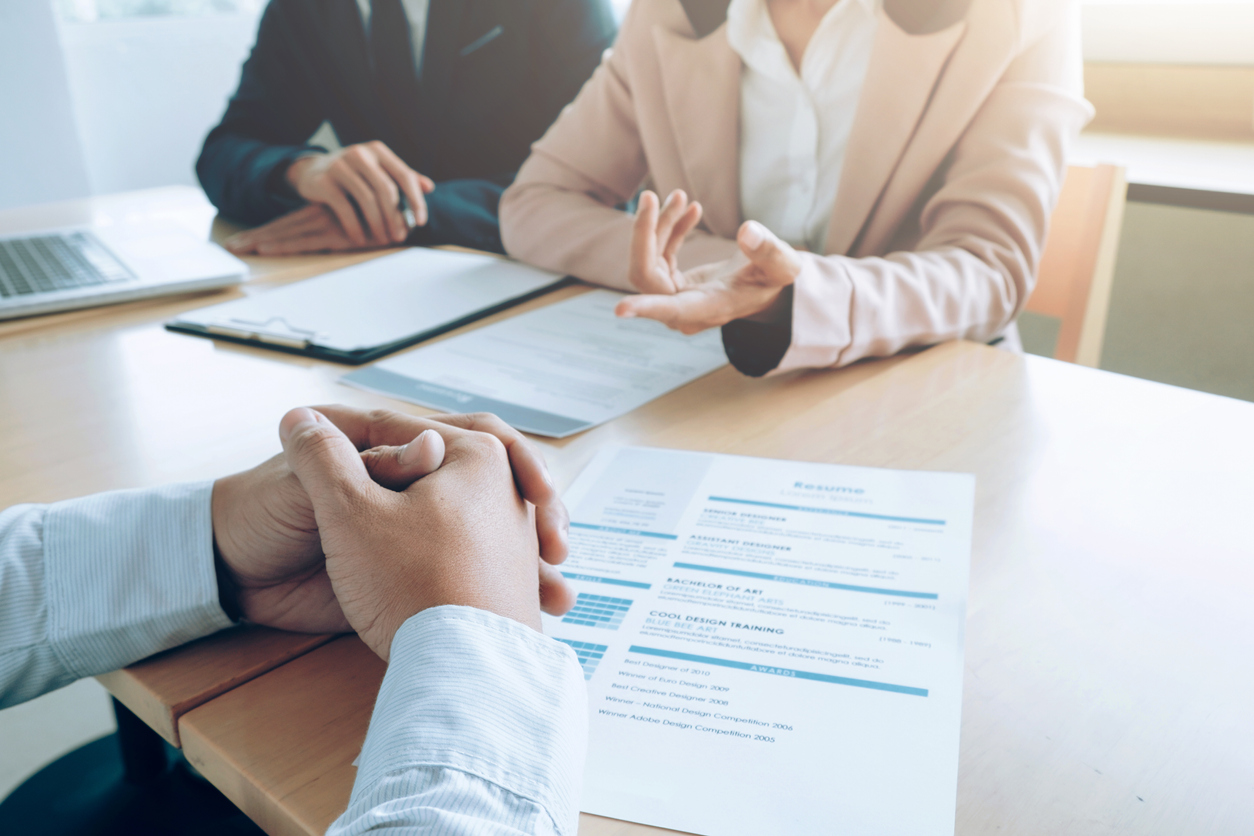 People in meeting with resume between them