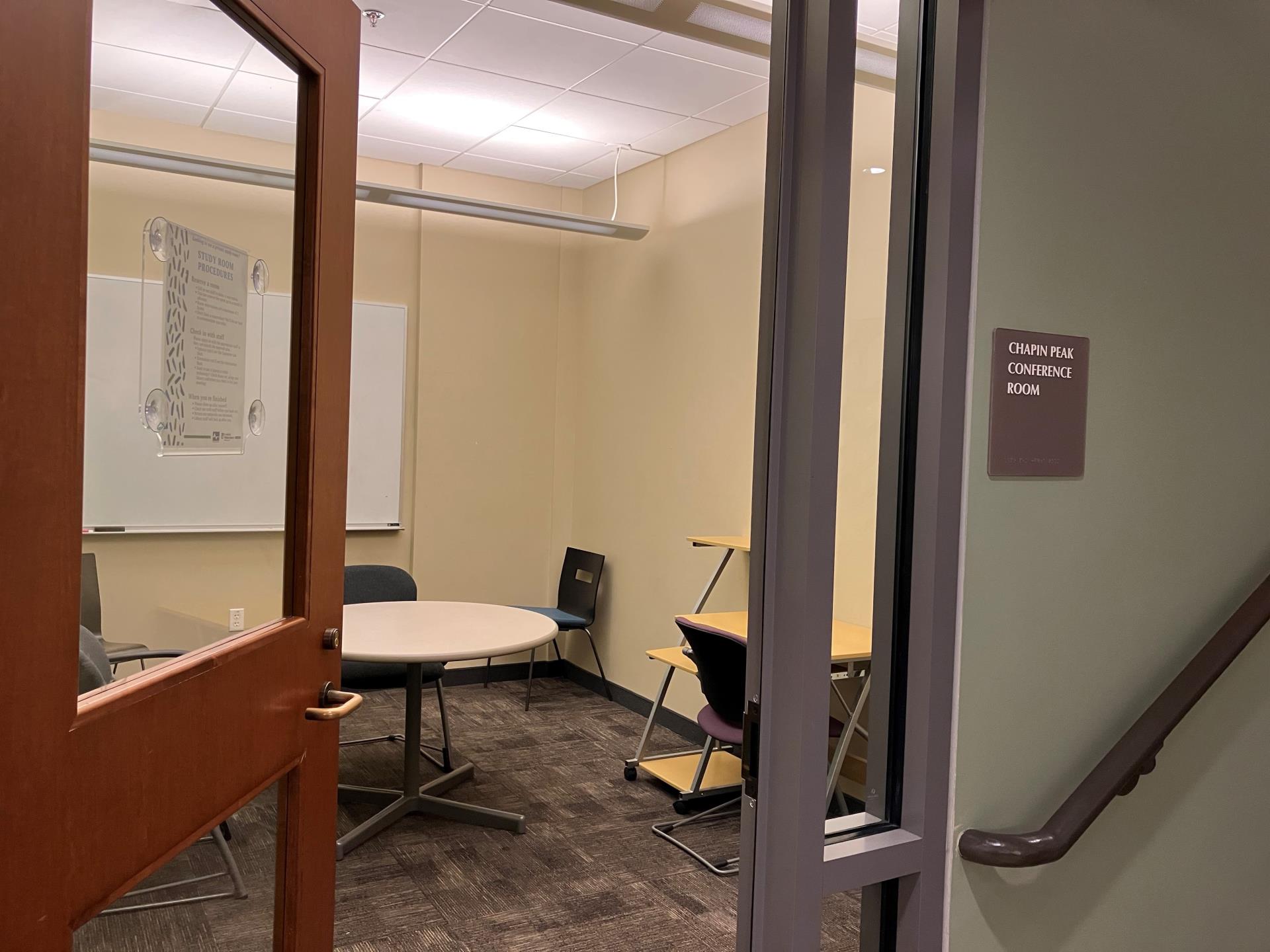 Door showing study room with chairs and table