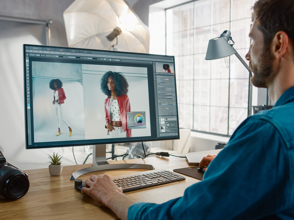 A Man using a computer to edit photos