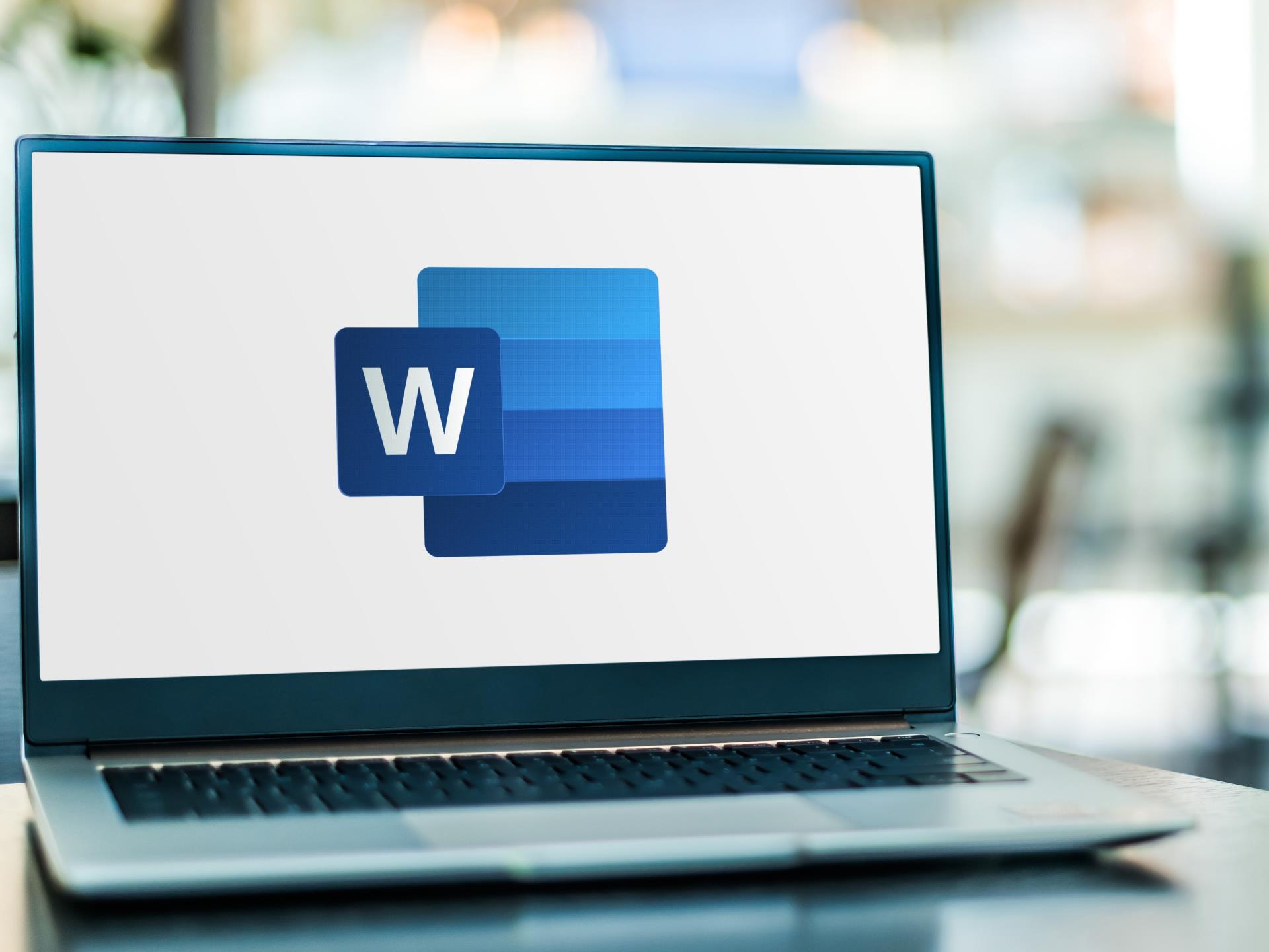 A laptop displaying the Microsoft Word logo