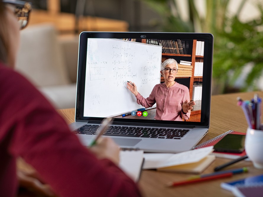 Woman watching an online class on a laptop